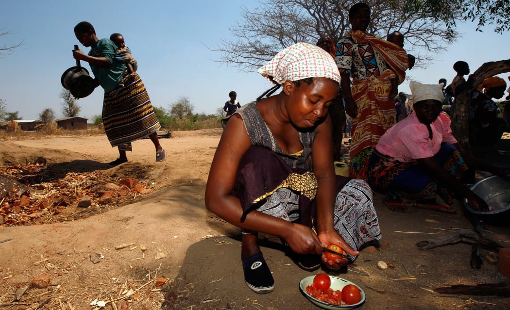 Villagers prepare food for a feast at the Nanthomba Primary School October 4, 2007 in Nanthomba, Malawi.
