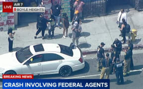 Aerial video from AIR7 showed LAPD officers and Los Angeles Fire Department firefighters at the crash site.