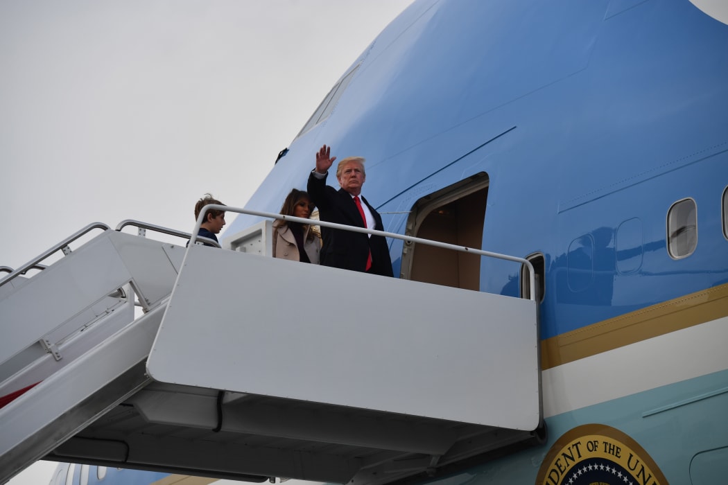 US President Donald Trump boards Air Force One in West Palm Beach, Florida with First Lady Melania Trump and son Barron Trump en route to Washington.