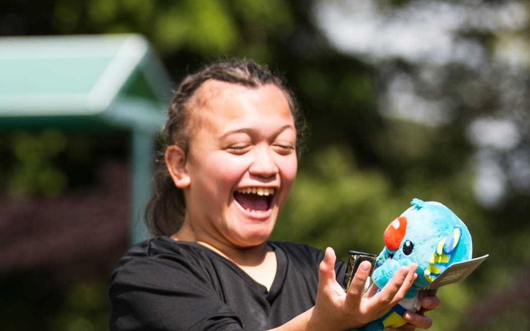 Young Para Athlete Matakorama Waipouri receives a Borobi Mascot at the Para Lawn Bowls Commonwealth Games announcement.