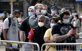 People wait in a queue for their Covid-19 coronavirus vaccination in Sydney