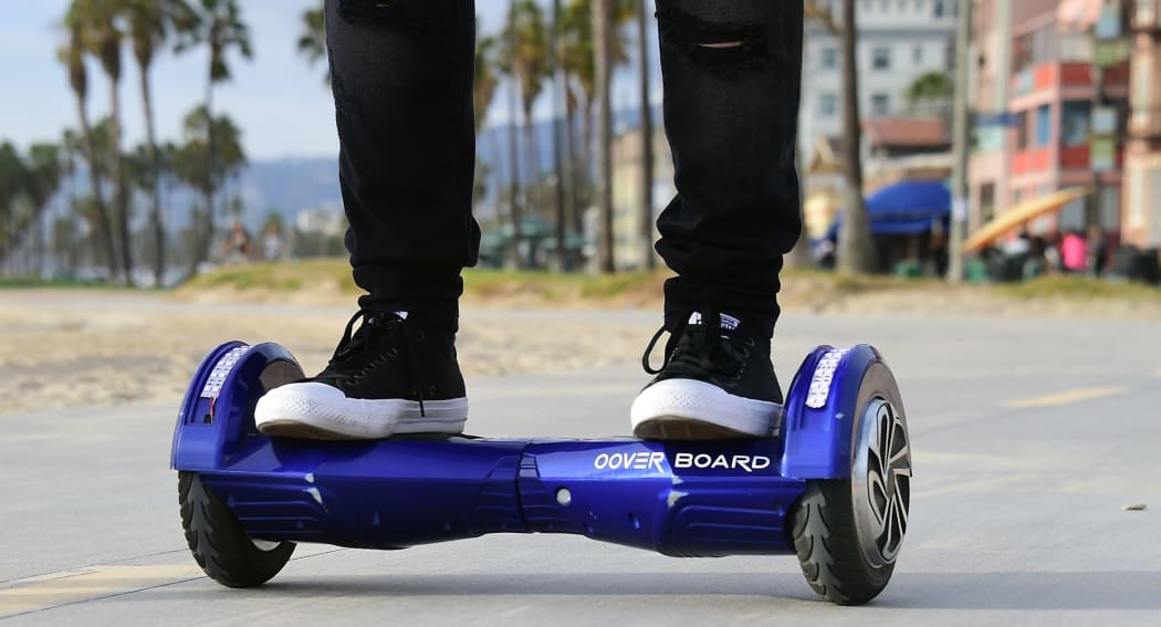 A man on his hoverboard on the Venice Beach boardwalk. AFP PHOTO/ FREDERIC J. BROWN