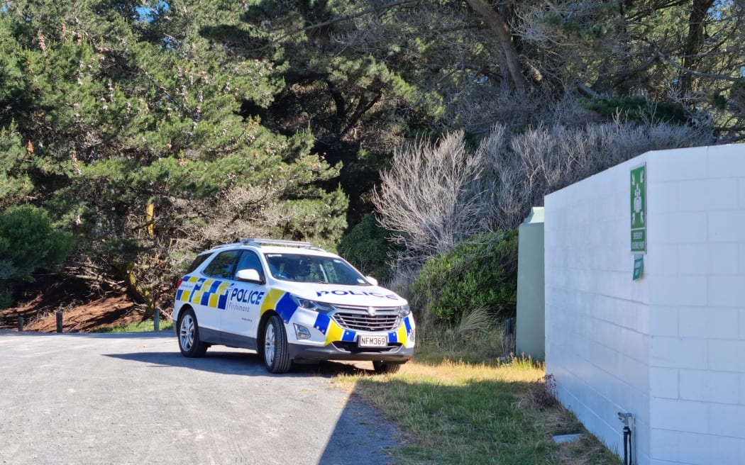 A police car is seen parked outside the Spencer Park Beach Surf Life Saving Club east of Kaiapoi in Canterbury after a water-related incident at Spencer Beach left one person dead and seven others injured on 13 November, 2022.