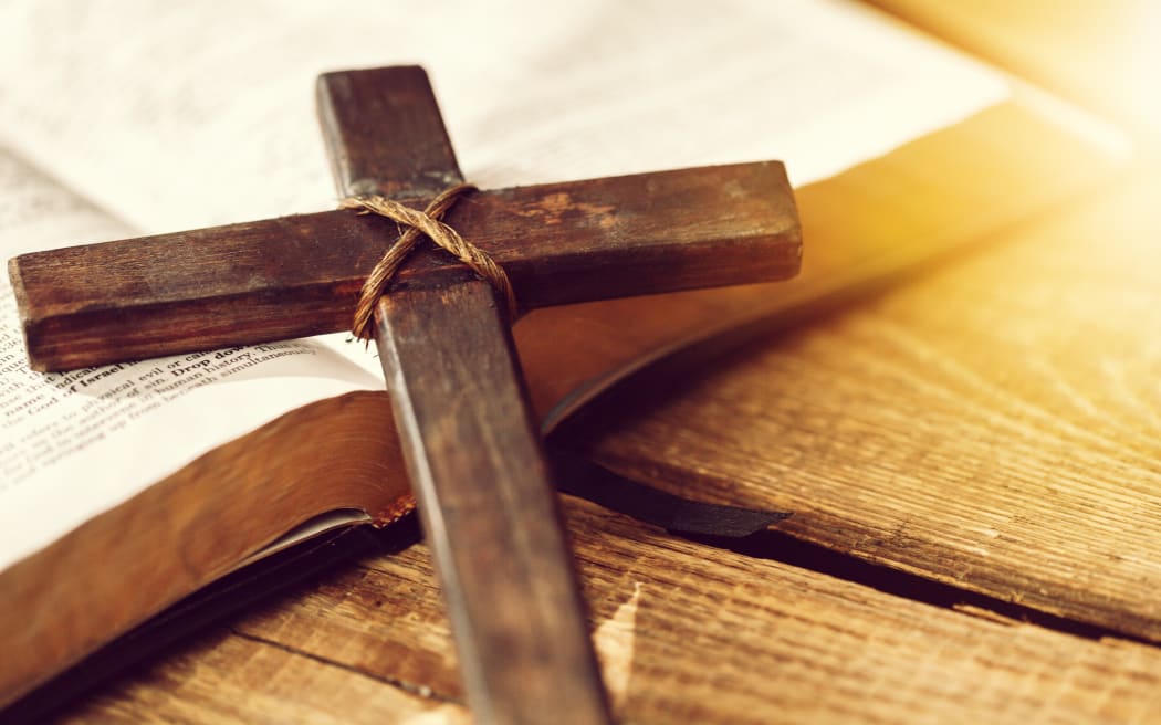 Holy Bible book and cross, close-up view