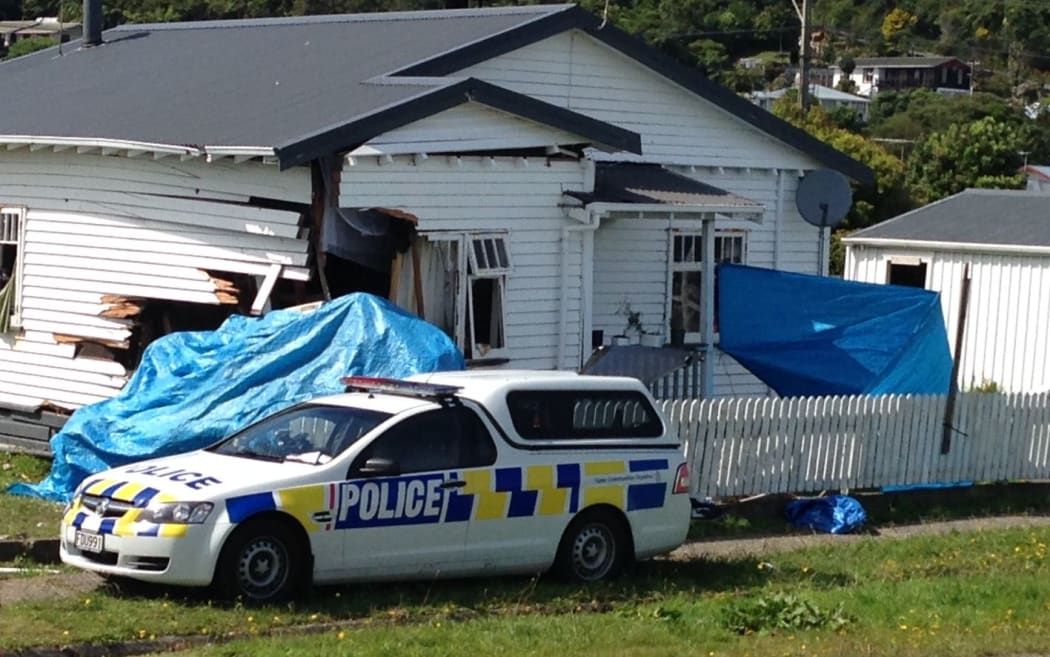 The crashed vehicle under tarpaulin at the High Street house.
