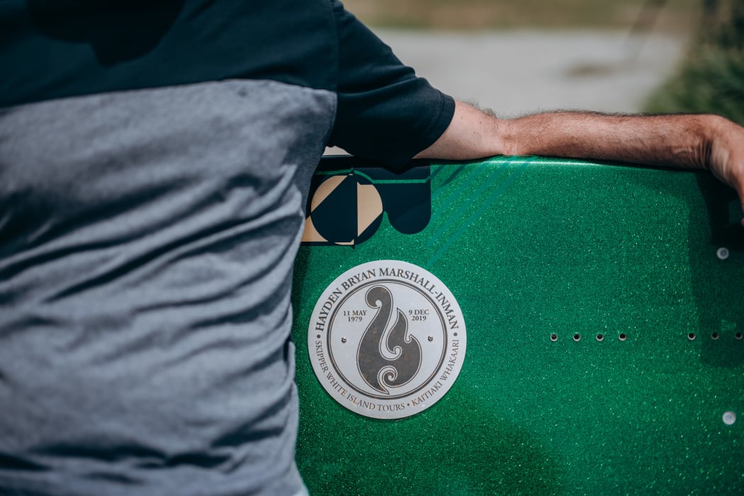 A surfboard bench in memory of tour guide Hayden Marshall-Inman whose body has not been recovered since the Whakaari White Island eruption.