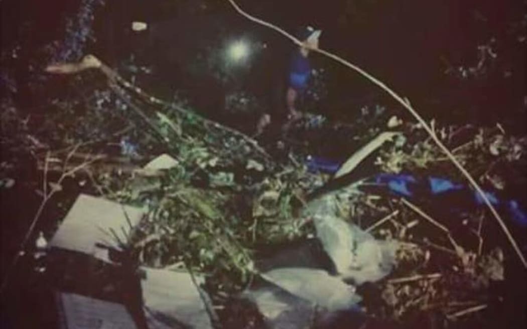 A photo shows one man among the belongings of the group which were strewn down the bank.