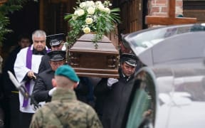 Men carry the coffin during the funeral of one of two victims of a missile that hit a southeastern Polish village near the border with Ukraine, in Przewodow on November 19, 2022. - The explosion of the missile occurred on November 15, 2022 as Russia targeted Ukraine with a massive attack on civilian infrastructure which left millions of households without power. Russian missiles hit cities across Ukraine, including Lviv near the Polish border. (Photo by JANEK SKARZYNSKI / AFP)
