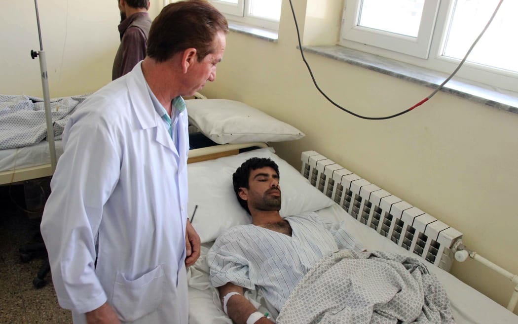A wounded Afghan receives treatment at a hospital in Kunduz province on August 9, 2015, after a Taliban attack in the northern Afghan city. The Taliban claimed responsibility for the attack. AFP PHOTO/Nasir Waqif