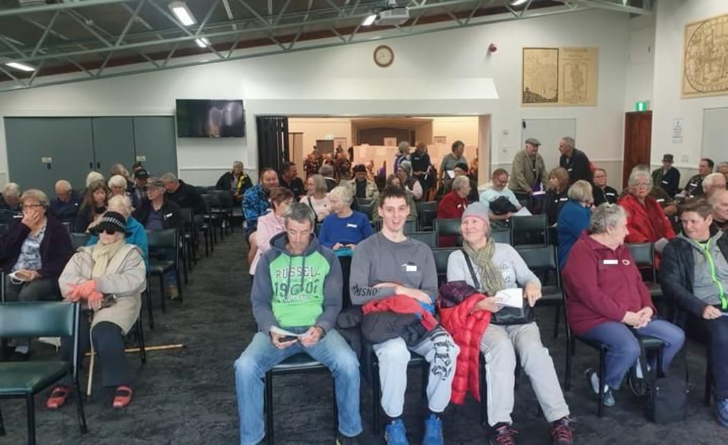 People wait in observation area after mass rural vaccination session in Stratford