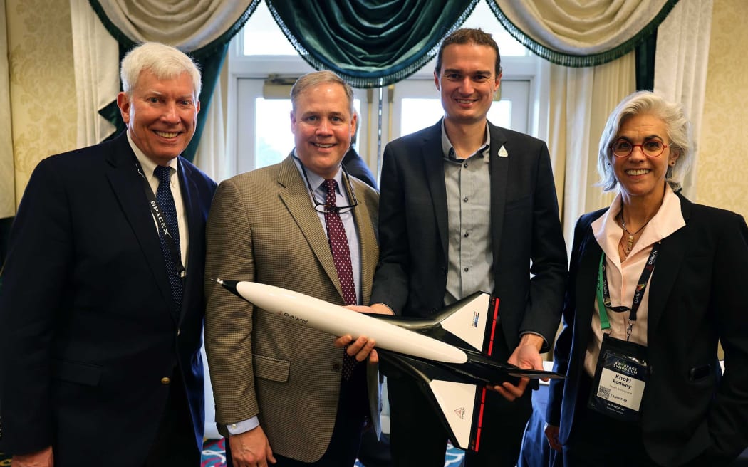 Dr. George Nield (Chairman, Global Spaceport Alliance), Jim Bridenstine (Managing Partner of the Artemis Group and Former NASA Administrator), Stefan Powell (CEO, Dawn Aerospace), and Khaki Rodway (Spaceplane Sales & Operations Director, USA, Dawn Aerospace) with a sub-scale Aurora spaceplane at the Oklahoma Breakfast during Space Symposium 2025 in Colorado Springs.