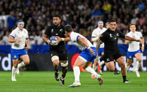 Ardie Savea gets support from All Blacks team-mate Codie Taylor against Italy in their pool match at the Rugby World Cup.