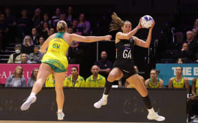 Silver Ferns captain Ameliaranne Ekenasio (R) wins possession ahead of Australia's Courtney Bruce during the first Constellation Cup Test in Wellington.