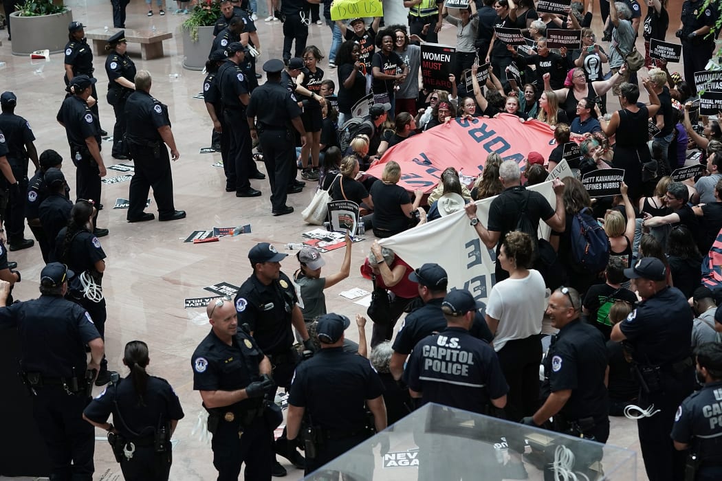 Members of US Capitol Police arrest demonstrators during a protest against the confirmation of Supreme Court nominee Judge Brett Kavanaugh.