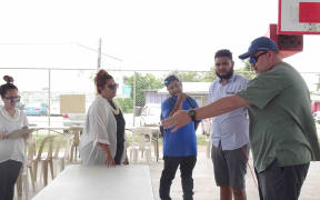Marshall Islands Director of Public Health Dr. Frank Underwood, right, works with Ministry of Health and Human Services staff to prepare a "test and treat" facility at a Majuro school gymnasium as part of Covid-19 preparations in this file photo from June.