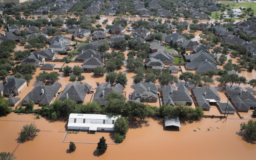 Homes are surrounded by floodwater after torrential rains from Harvey pounded Southeast Texas.