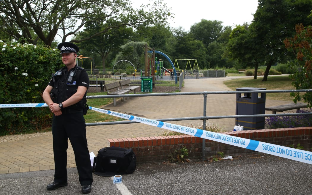 A police officer stands at a cordon at Queen Elizabeth Gardens in Salisbury.