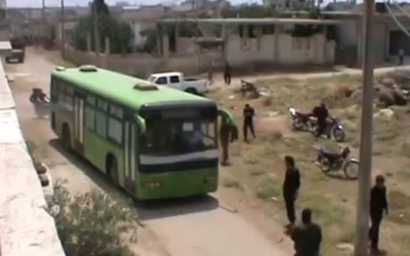 A bus takes activists out of Homs.