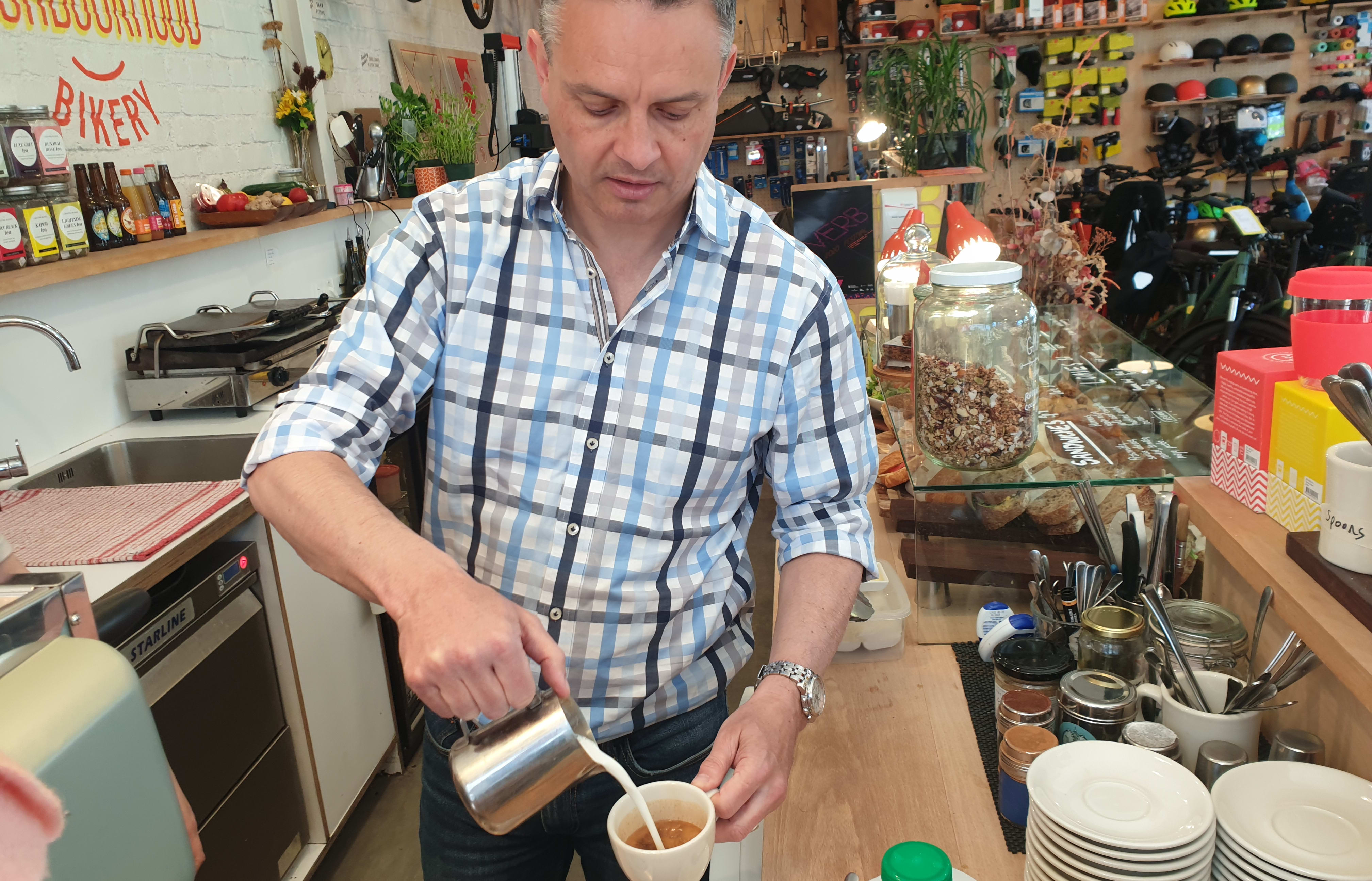 Green Party co-leader James Shaw shows off his barista experience while campaigning on 16 October, 2020.