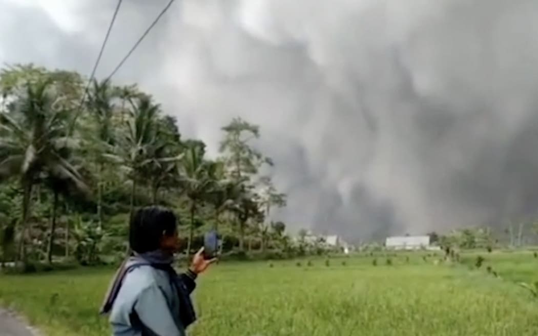 A screen grab from a video shows smoke and ash in the sky after the Semeru Volcano erupted in East Java, Indonesia on 4 December 2022.