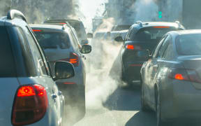 pollution from the exhaust of cars in the city in the winter. Smoke from cars on a cold winter day