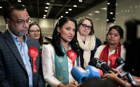 Rushanara Ali MP Labour Party for Bethnal Green and members of her party surrounded by microphones being interviewed by the press, ExCel Centre London United Kingdom, on July 4 2024. Part of the UK General Election count for the Tower Hamlets borough.
Rushanara Ali deputee du parti Labour pour Bethnal Green et des membres de son parti entoures de microphones en train d etre interviewes par la presse, ExCel Centre Londres Royaume Uni, le 4 juillet 2024. Dans le cadre du depouillement des elections generales pour l arrondissement de Tower Hamlets. (Photo by Emil Lombardo / Hans Lucas via AFP)