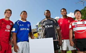 The captains of Canada A, Argentina Pampas XV, Samoa A, Fiji Warriors, Tonga A and Junior Japan pose with the Pacific Challenge Trophy.