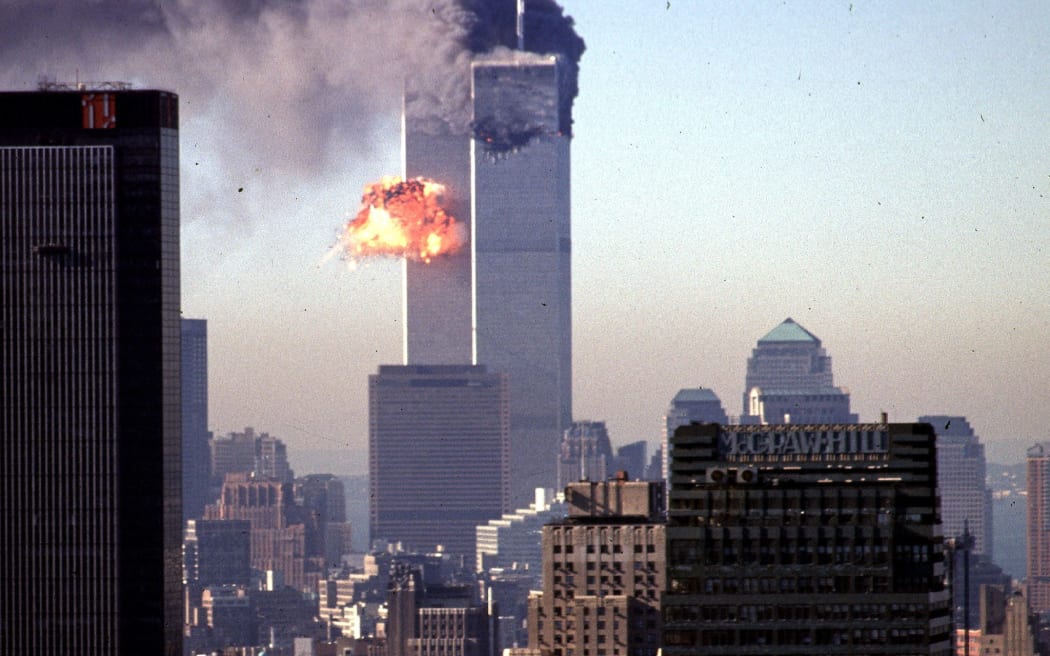 (FILES) In this file photo smoke and flames erupt from the twin towers of the World Trade Center after commercial aircraft were deliberately crashed into the buildings in lower Manhattan, New York on September 11, 2001.