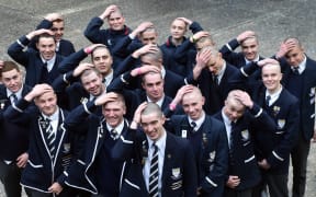 Otago Boys' High School students hold their freshly shaved lids in their hands.