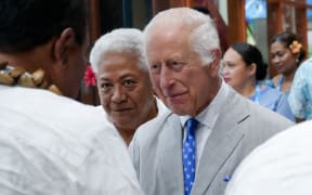 Britain's King Charles III (C) is introduced to dignitaries by Samoa's Prime Minister Fiame Naomi Mata'afa (2nd L) as he arrives at Apia Airport for the Commonwealth Heads of Government Meeting (CHOGM) in Apia on October 23, 2024. (Photo by POOL / AFP)