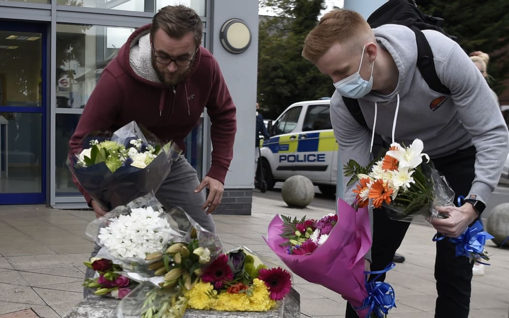 Well-wishers place flowers outside the Croydon Custody Centre in south London on September 25, 2020, following the shooting of a British police officer by a 23-year-old man being detained at the centre. -