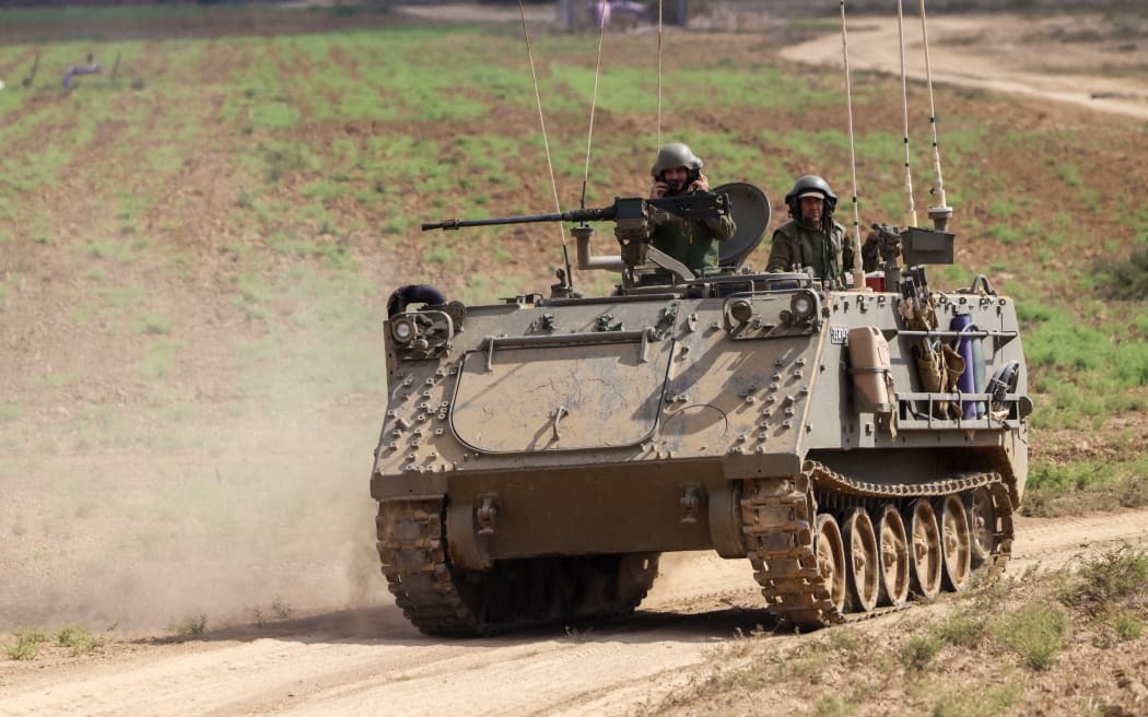 EDITORS NOTE: Graphic content / Israeli soldiers hold a position along the Israel-Gaza border on October 11, 2023. Israel declared war on Hamas on October 8 following a shock land, air, and sea assault by the Gaza-based militant group. The death toll in Israel has surged above 1,000 following the worst attack in the country's 75-year history, while Gaza officials have reported 900 people killed so far. (Photo by Jack Guez / AFP)