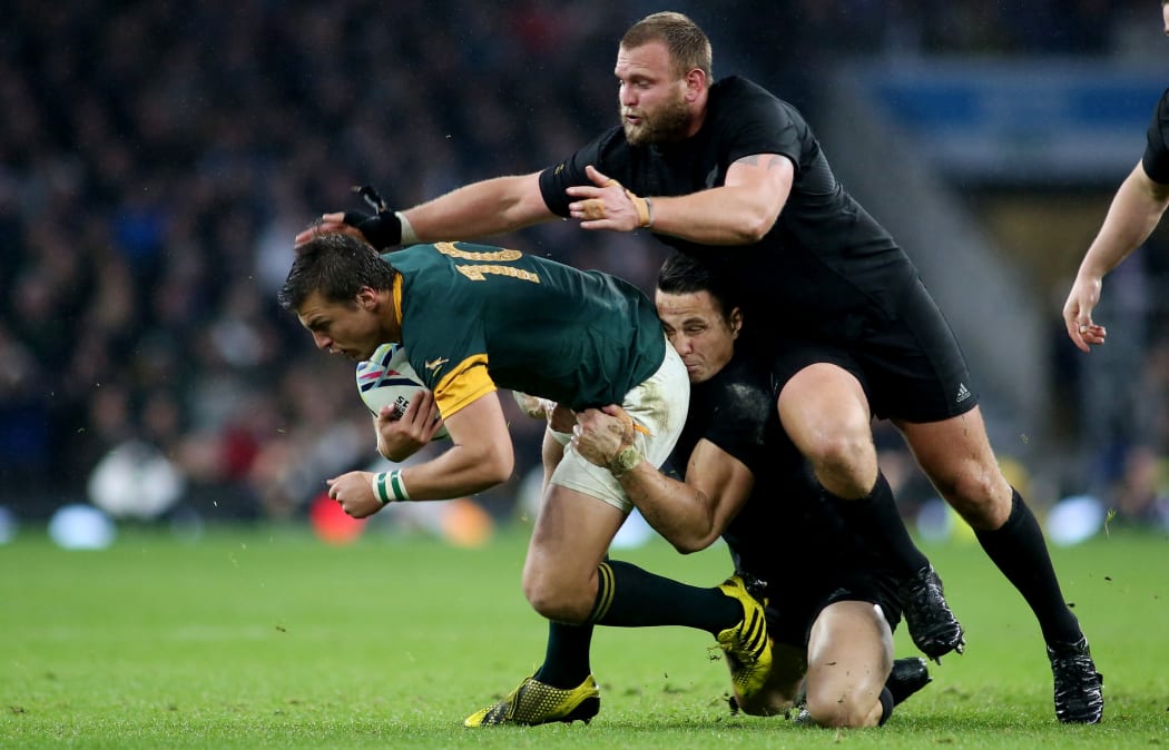 Handre Pollard of South Africa is tackled by Sonny Bill Williams