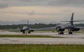 In this US Air Force image obtained from the US Defense Department, two US Air Force B-1B Lancers prepare to take off from Andersen Air Force Base, Guam to fly sequenced bilateral missions with two Japan Air Self-Defense Force (JASDF) F-15s and two Republic of Korea air force (ROKAF) F-15Ks in the vicinity of the Sea of Japan, on October 10, 2017. The US flies two supersonic heavy bombers over the Korean peninsula in a fresh show of force against North Korea's nuclear and missile threats. (Photo by Joshua SMOOT / US AIR FORCE / AFP) / RESTRICTED TO EDITORIAL USE - MANDATORY CREDIT "AFP PHOTO / US AIR FORCE / Staff Sgt. Joshua Smoot" - NO MARKETING NO ADVERTISING CAMPAIGNS - DISTRIBUTED AS A SERVICE TO CLIENTS