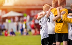 Kids Sport Team Gathering. Children Play Sports. Boys in Sportswear Jersey Uniforms Having Shout Team. Youth Sports For Children. Youth Football Academy Background with Copy Space