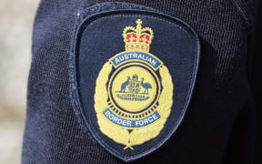 Australian Border Force logo on the uniform of an officer in Brisbane