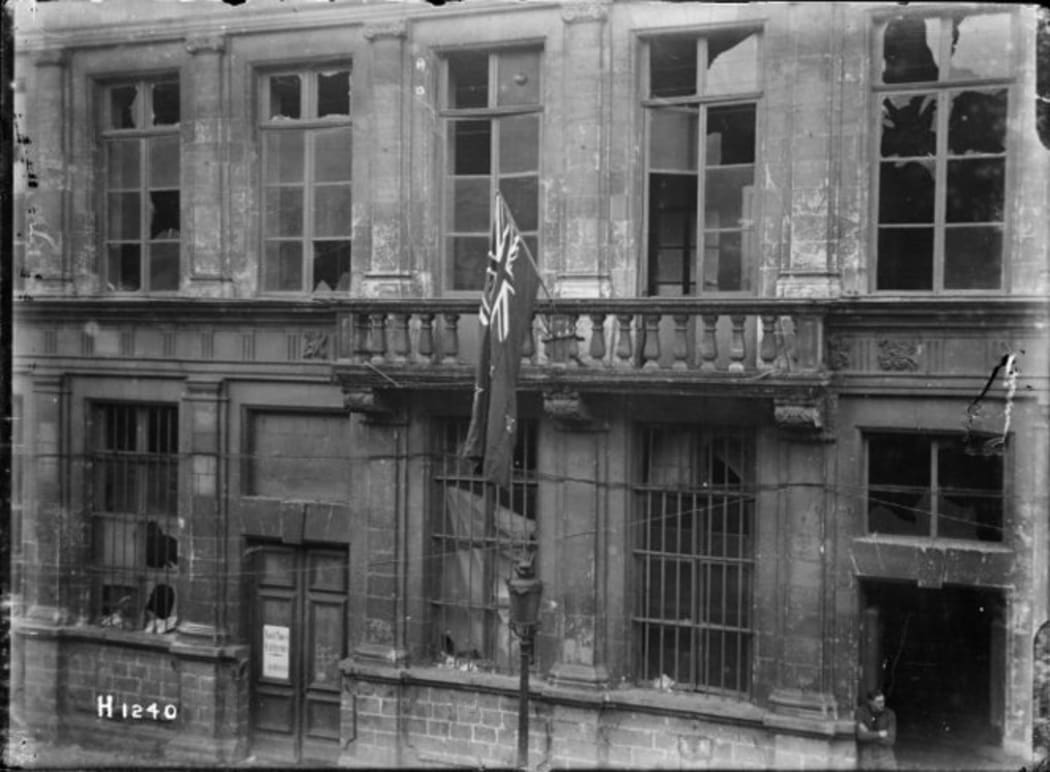 New Zealand flag handing outside Le Quesnoy's war-damaged town hall in 1918