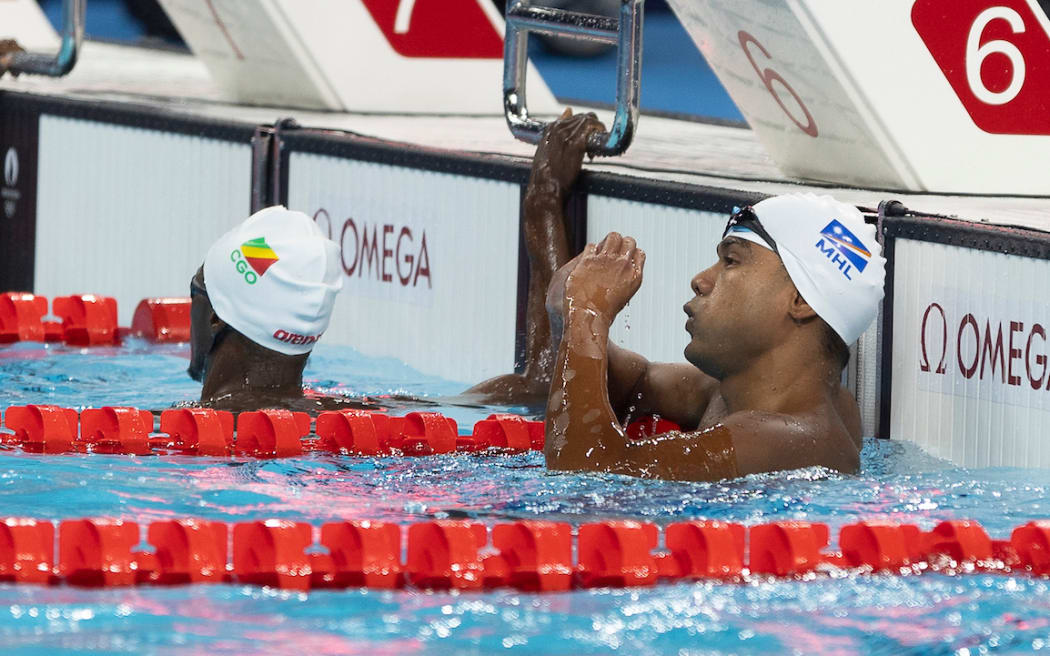 Marshall Islands Philip Kinono in the pool, at the end of his race.