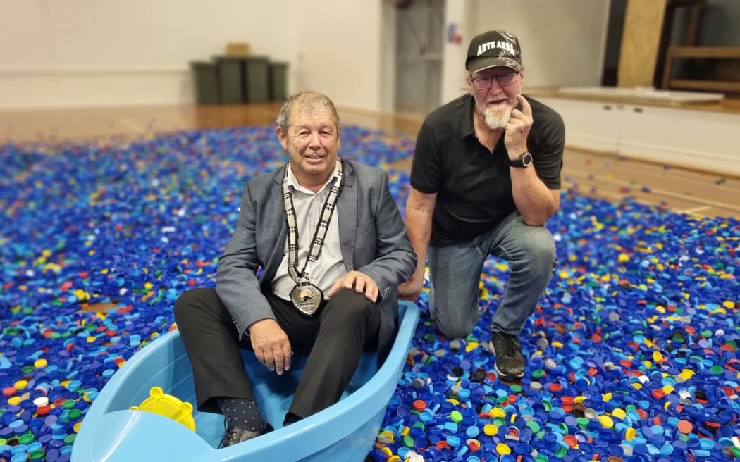 Stratford mayor Neil Volzke and Waste Education Manager Peter McMamara in a sea of cream and milk bottle lids