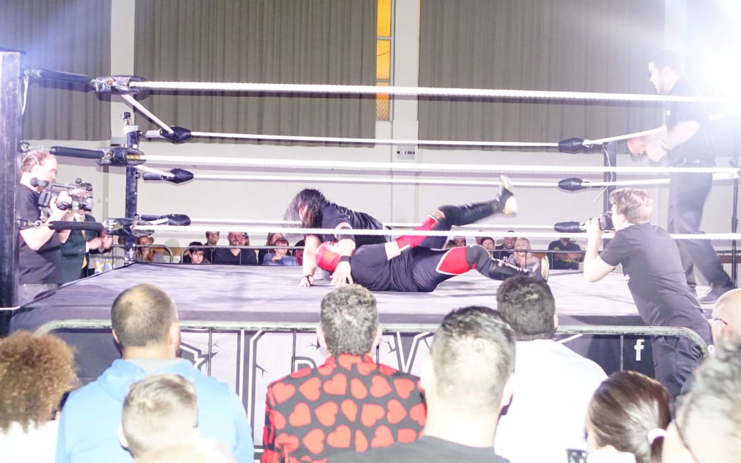 Michel Mulipola, having dropped his book persona, enters the wrestling ring as 'Lyger.'