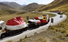 The truck convoy carrying the Auckland Farmers Santa passes the summit of the Lindis Pass on the way to Wanaka yesterday.