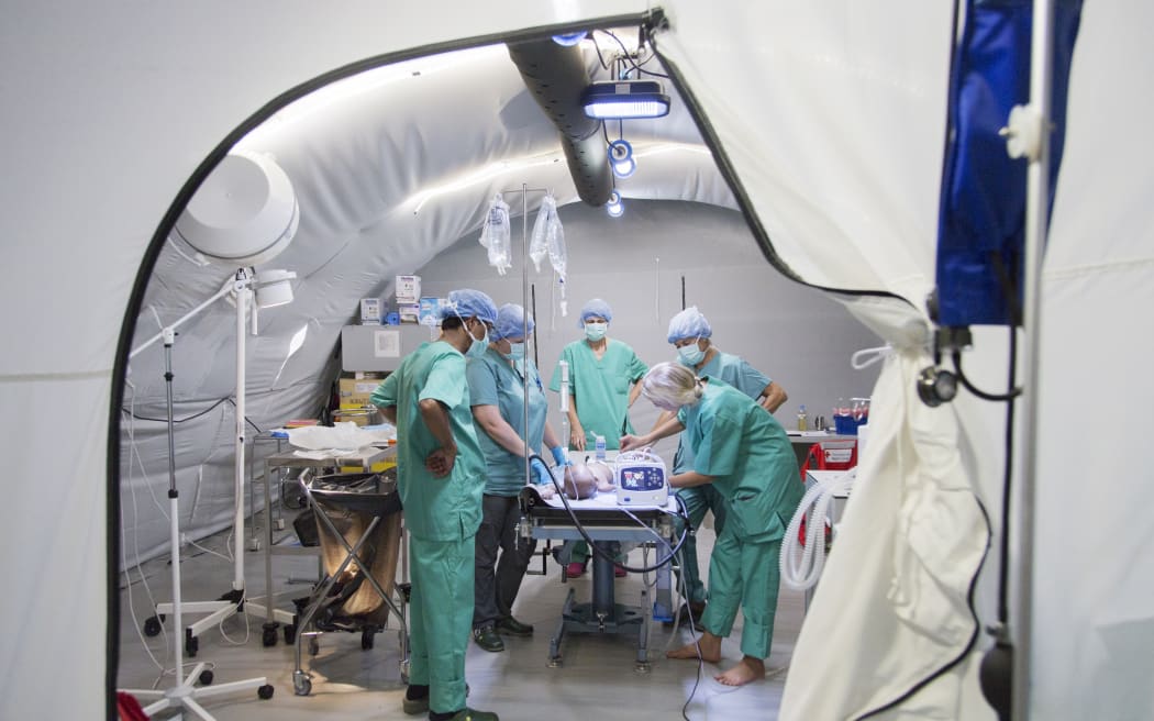 Red Cross staff operate on a baby boy in the field hospital. Credit: Emilia Kangasluoma/IFRCNo caption