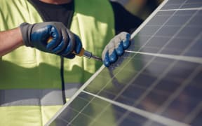 Worker and solar panels.