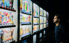 man at vending machine