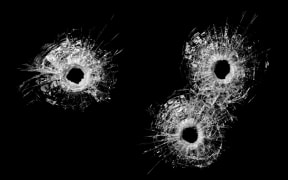 A banned Australian sports scientist was injured after shots were fired into his home.