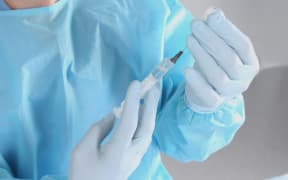 Syringe, medical injection in hand, palm or fingers.