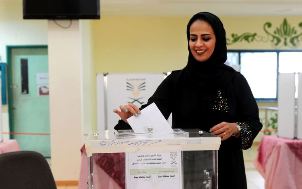 A Saudi woman casts her ballot in a polling station in the coastal city of Jeddah, on December 12, 2015. AFP PHOTO / STR