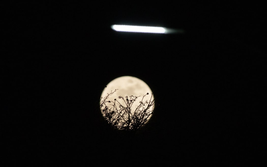 The 'Blue Supermoon', the biggest and brightest full moon of the year, is seen over Bogota, Colombia, on August 30, 2023 (Photo by Daniel Garzon Herazo/NurPhoto) (Photo by Daniel Garzon Herazo / NurPhoto / NurPhoto via AFP)