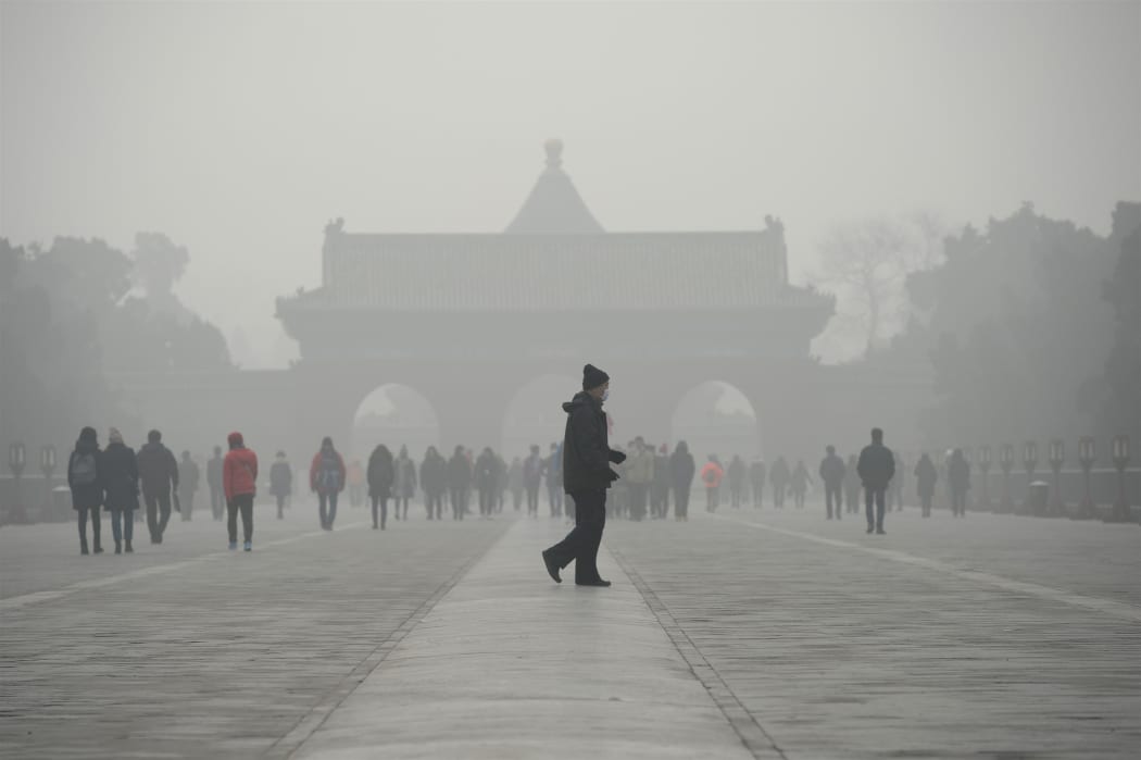 A man walks through smog at a the Temple of Heaven park in Beijing last month.