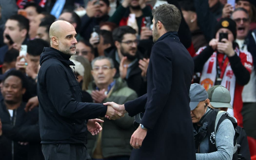 Manchester City's Spanish manager Pep Guardiola (L) shakes hands with Manchester United's English Interim head coach Michael Carrick (R) after the English Premier League football match between Manchester United and Manchester City at Old Trafford in Manchester, north west England, on January 17, 2026. United won the game 2-0. (Photo by Darren Staples / AFP) / RESTRICTED TO EDITORIAL USE. NO USE WITH UNAUTHORIZED AUDIO, VIDEO, DATA, FIXTURE LISTS, CLUB/LEAGUE LOGOS OR 'LIVE' SERVICES. ONLINE IN-MATCH USE LIMITED TO 120 IMAGES. AN ADDITIONAL 40 IMAGES MAY BE USED IN EXTRA TIME. NO VIDEO EMULATION. SOCIAL MEDIA IN-MATCH USE LIMITED TO 120 IMAGES. AN ADDITIONAL 40 IMAGES MAY BE USED IN EXTRA TIME. NO USE IN BETTING PUBLICATIONS, GAMES OR SINGLE CLUB/LEAGUE/PLAYER PUBLICATIONS. /